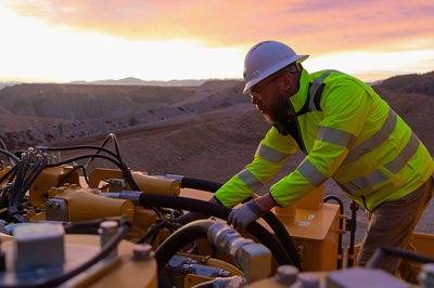 Man wearing hi vis uniform working on machine