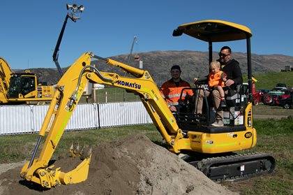 Child on Komatsu PC18 mini digger